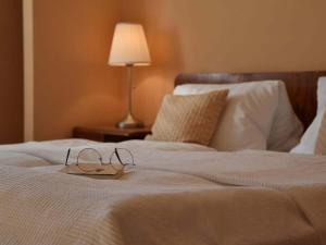 a pair of glasses sitting on top of a bed at Holiday apartment with 1 bedroom in Aich