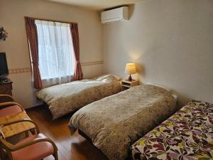 Ένα ή περισσότερα κρεβάτια σε δωμάτιο στο Pension Avenue