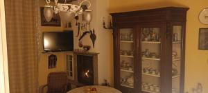 a living room with a fireplace and a china cabinet at b&b Casa Galletti in Busalla