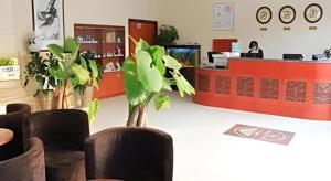 a lobby with a counter with a woman at a desk at GreenTree Inn Jinan Bus Terminal in Jinan