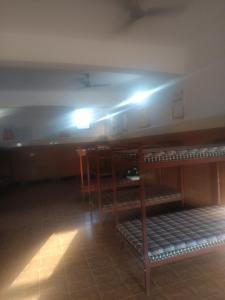 a room with bunk beds with lights on the ceiling at Astha veg restaurant or guesthouse in Bareilly