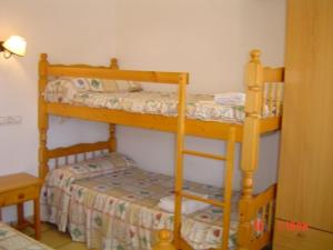 a bedroom with two bunk beds in a room at Apartamentos Famara in Lloret de Mar +63 photos