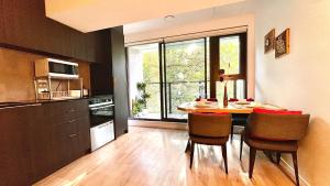 a kitchen with a table and chairs and a window at Modern apartment in the city center in Auckland