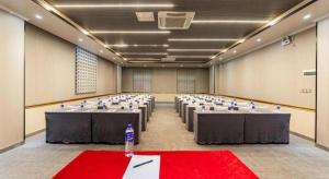 a large room with tables and chairs with a bottle of water at GreenTree Inn Hainan Haikou Jinniu Road Business Hotel in Haikou