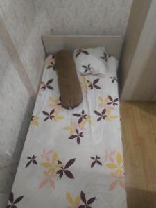 a bed in a box with flowers on it at Aparta Homestay in Pekayon Satu