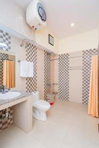 a bathroom with a toilet and a clock on the ceiling at Sitara Hotel & Resort in the lap of nature, Mussoorie in Mussoorie