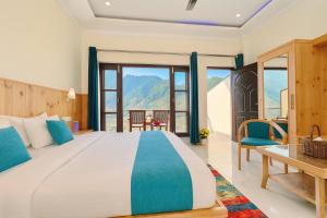 a bedroom with a large bed with a view at Sitara Hotel & Resort in the lap of nature, Mussoorie in Mussoorie