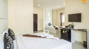 um quarto de hotel com uma cama e uma sala de estar em The Rich Residence em Ban Tha Kup