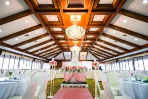 a banquet hall with white tables and chairs and a chandelier at Pinehurst Golf Club and Hotel in Ban Bang Khan +81 photos