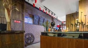 a kitchen with a counter and a brick wall at James Joyce Coffetel·Suqian Bus Station in Suqian