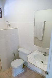 a white bathroom with a toilet and a sink at Marine Chaweng Beach Resort in Chaweng
