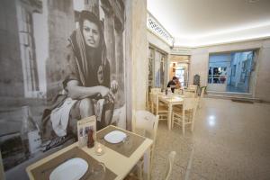 a restaurant with a large painting of a woman on the wall at GK Athens by GK Hospitality Group in Athens