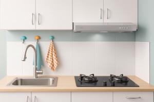 a kitchen with a sink and a stove at Dhonveli in Male City