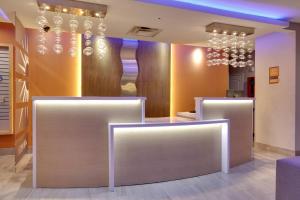 a room with three counters with lights on the wall at La Quinta by Wyndham Dallas Love Field in Dallas +25 photos