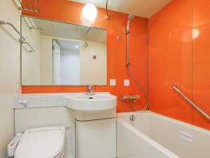 a bathroom with a sink and a toilet and a mirror at Comfort Inn Tsuchiura Ami in Tsuchiura +26 photos