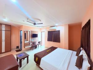 a bedroom with a bed and a living room at ফোর স্কয়ার Four Square Lite Heaven Digha Near The Sea Beach in Digha