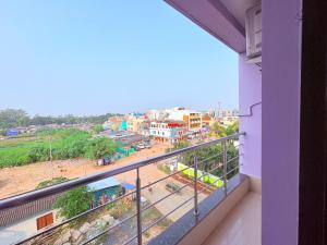 a balcony with a view of a city at ফোর স্কয়ার Four Square Lite Heaven Digha Near The Sea Beach in Digha