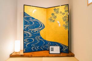 a picture of a painting of a peacock at Private stay MIYAJIMA tonbo-AND in Hatsukaichi