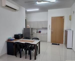 a kitchen with a table and chairs and a refrigerator at Homestay MKH Boulevard 1 in Kajang