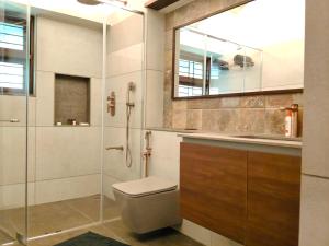 a bathroom with a toilet and a shower and a sink at Aelam Acres in Chillithodu +46 photos