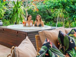 two women are sitting in a jacuzzi tub at The First House Luxury Villa, Eden Rock Estate in Pennington