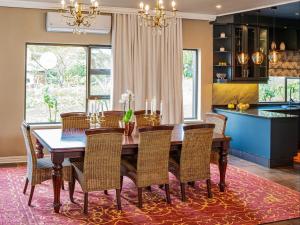 a dining room with a wooden table and chairs at The First House Luxury Villa, Eden Rock Estate in Pennington +22 photos