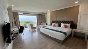 a bedroom with a large bed and a balcony at Ululani Bali in Uluwatu +20 photos