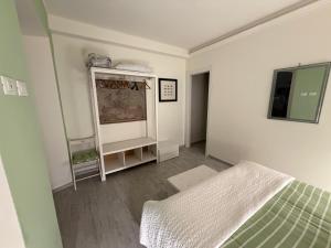 a bedroom with a bed and a mirror in it at Rosale in Forte dei Marmi +2 photos