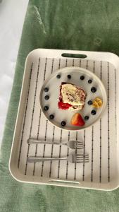 a plate with a piece of cake on a cooling rack at Blue Horizon Bed and Breakfast in Maseru