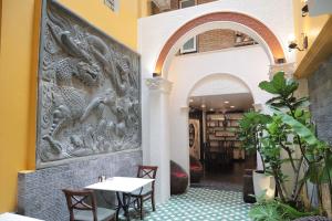 an archway with tables and chairs in a restaurant at Halo Boutique Ben Thanh Hotel in Ho Chi Minh City
