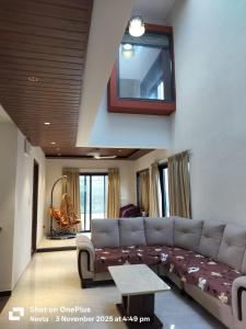 un soggiorno con un divano e una TV di BachavatS Villa Family Guest House a Kharakvasla