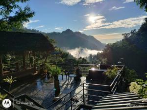 a person sitting at a table looking out over a valley at Ella Lucky Panoramic in Ella