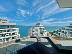 a balcony with a table and a view of the ocean at Mandala Hotel & Resort 5 Star in Mui Ne