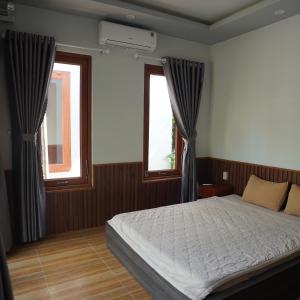 Giường trong phòng chung tại Homestay - Villa Ông Đề