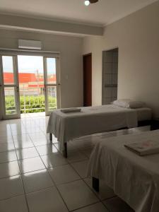 Postel nebo postele na pokoji v ubytování Fabiel Palace Hotel