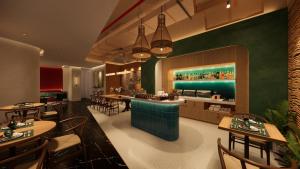 a restaurant with tables and chairs and a bar at NiK Hotel Nguyen Trai in Ho Chi Minh City