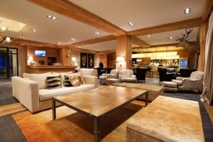 a large living room with couches and a table at Grand Hotel Caviahue in Caviahue