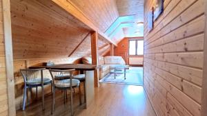 a room with a table and chairs in a cabin at Wiślany Raj in Wisła