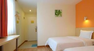 Una cama o camas en una habitación de 7 Days Inn Wuhan Hanyang Wanda Plaza