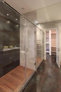 a bathroom with a walk in shower and a sink at Metro apartment in Yerevan