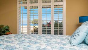 een slaapkamer met een bed en een groot raam bij Ocean View in Koolina Oasis in Honokai Hale