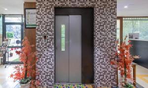 a brick wall with a door in a building at Treebo Executive Suites in Gandhinagar