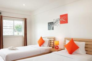 a bedroom with two beds and a window at Meesuk ChiangRai Hotel in Chiang Rai +180 photos