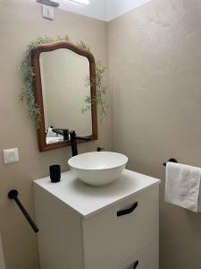 a bathroom with a white sink and a mirror at Superbe appartement loveroom avec balnéo Dolce notte in Carbonne +28 photos
