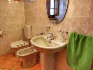 Castel FocognanoRustic Holiday Home in Ortignano with Swimming Pool的浴室里有洗手池、马桶和镜子。