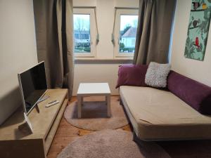 a living room with a couch and a table at FeWo Aisch in Bad Windsheim