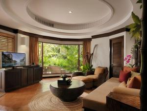 a large living room with a couch and a table at Rayavadee - Deluxe Pavilion in Railay Beach