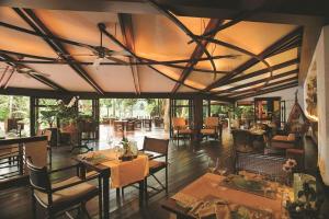 a dining room with tables and chairs and a large ceiling at Rayavadee - Pool Pavilion in Railay Beach