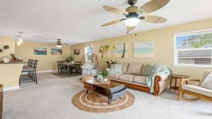 a living room with a couch and a table at Your Resort Home Walk to Disney & Beach in Honokai Hale