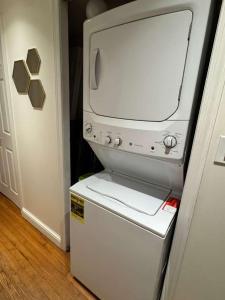 a television sitting on top of a refrigerator at Bright 2BR and1BA Home Near Old Town, Metro, Airport and Potomac Yard in Alexandria +3 photos